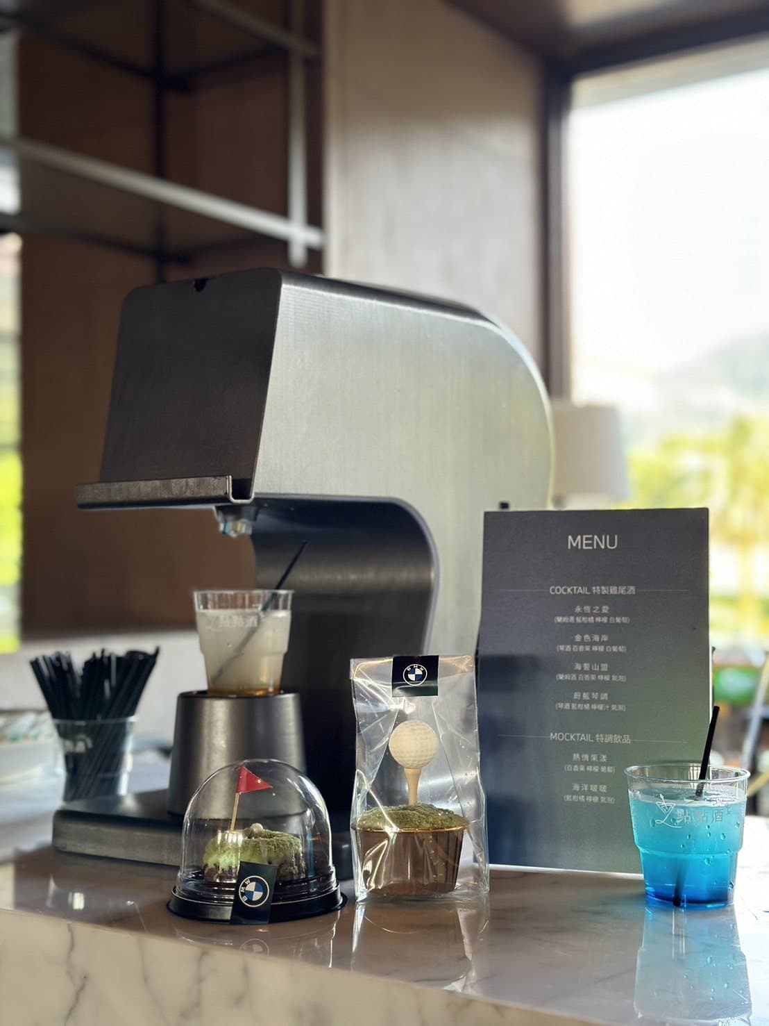 Close-up of the robot bartender pouring a blue signature cocktail