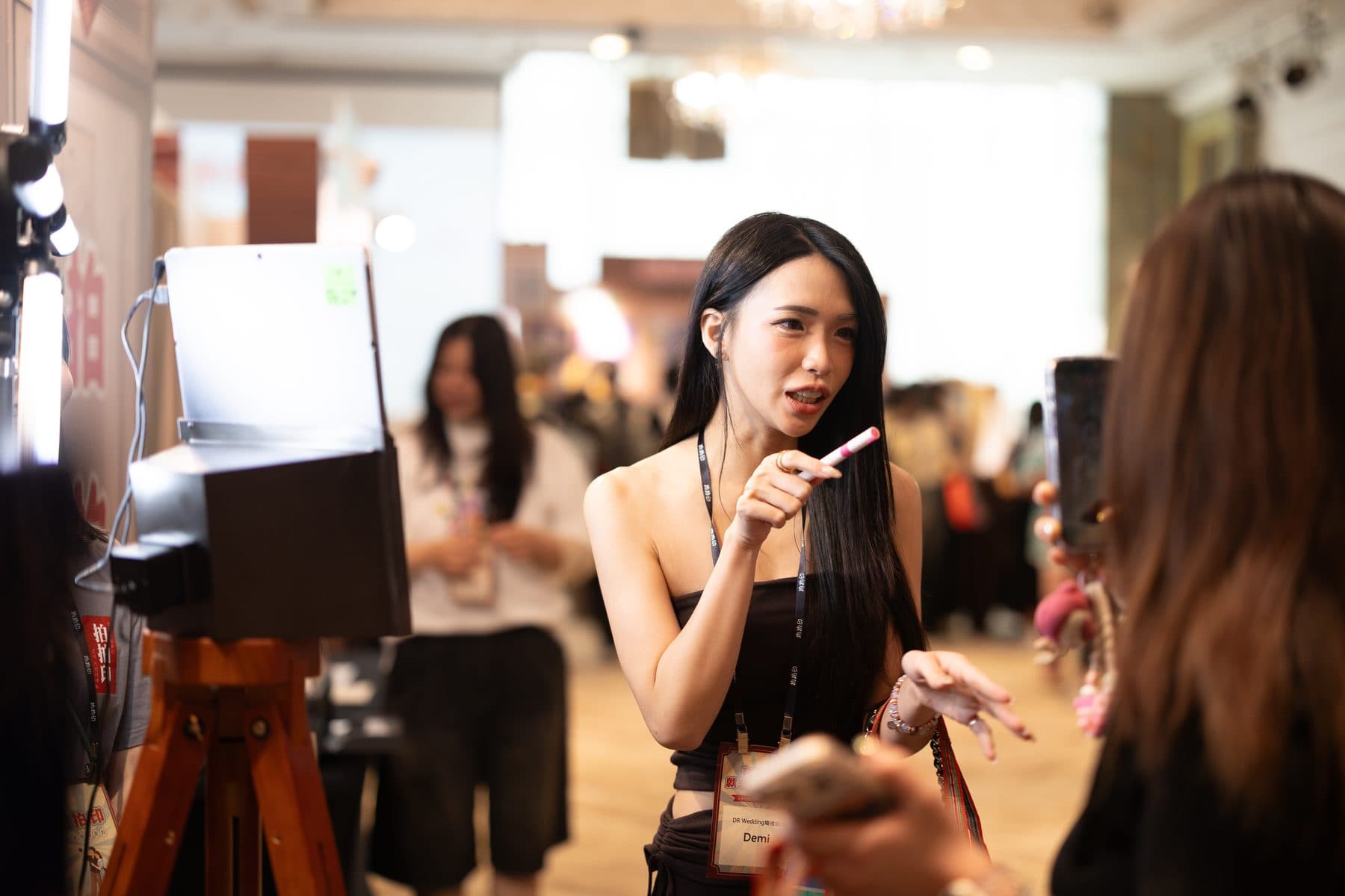 A crew member holding the stylus while explaining how the signing works