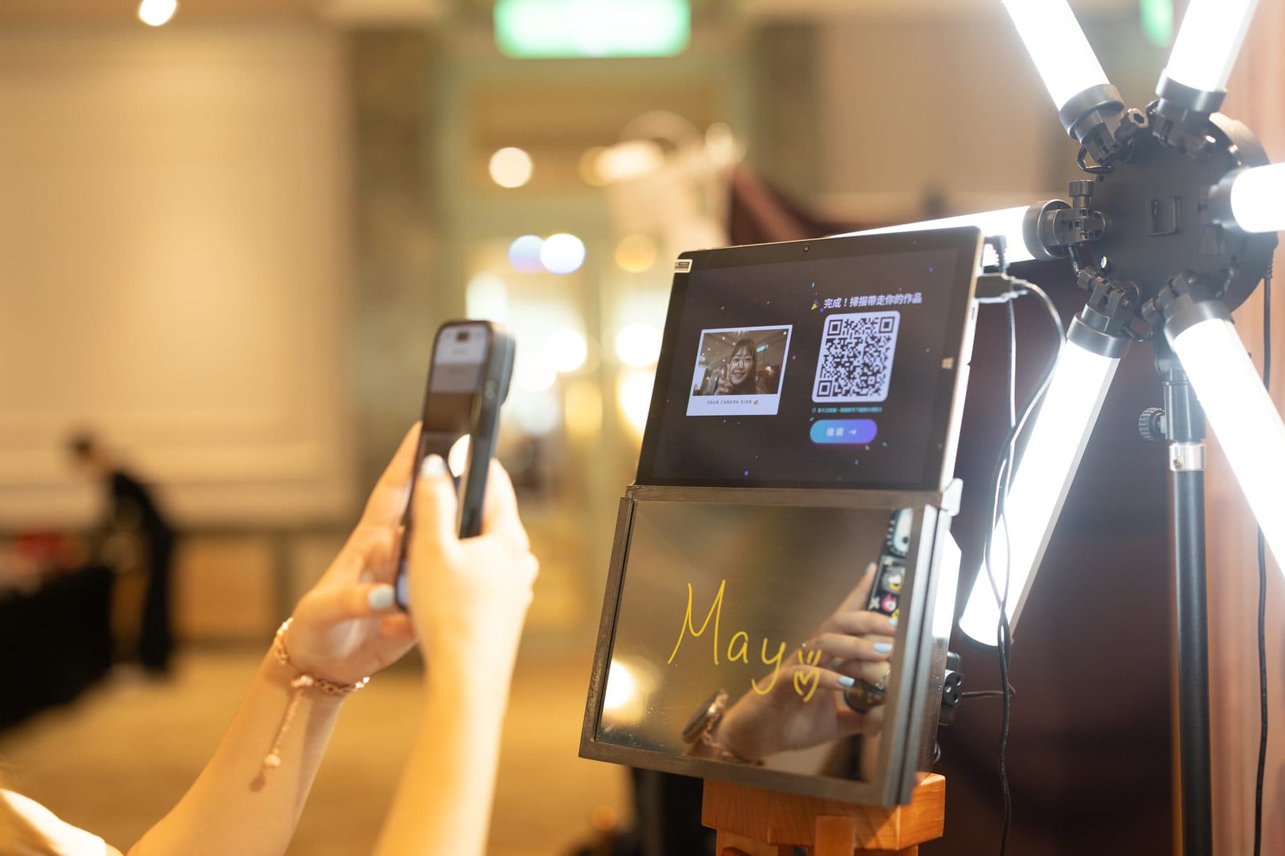 A guest scanning the QR code on a print with a phone