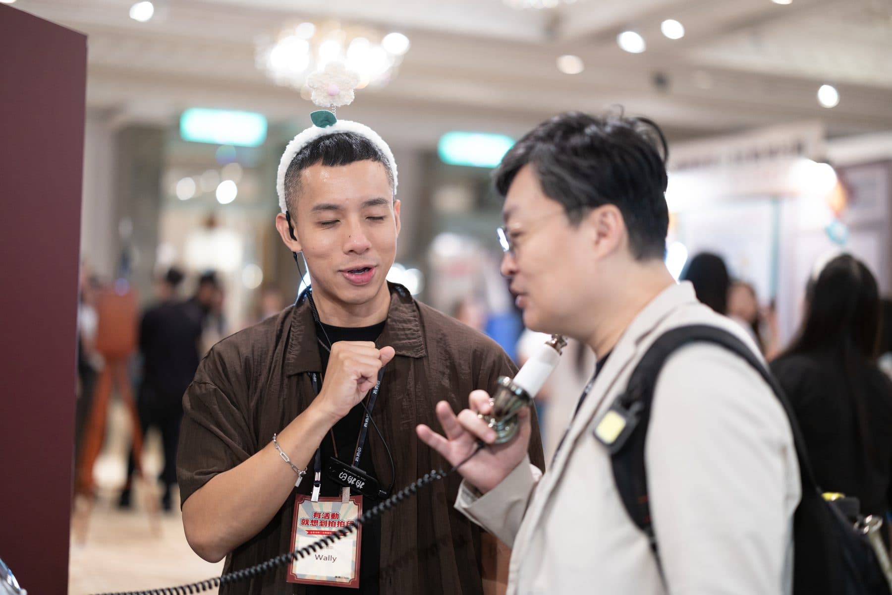 A guest recording a message into the handset at the video guestbook while a host guides them