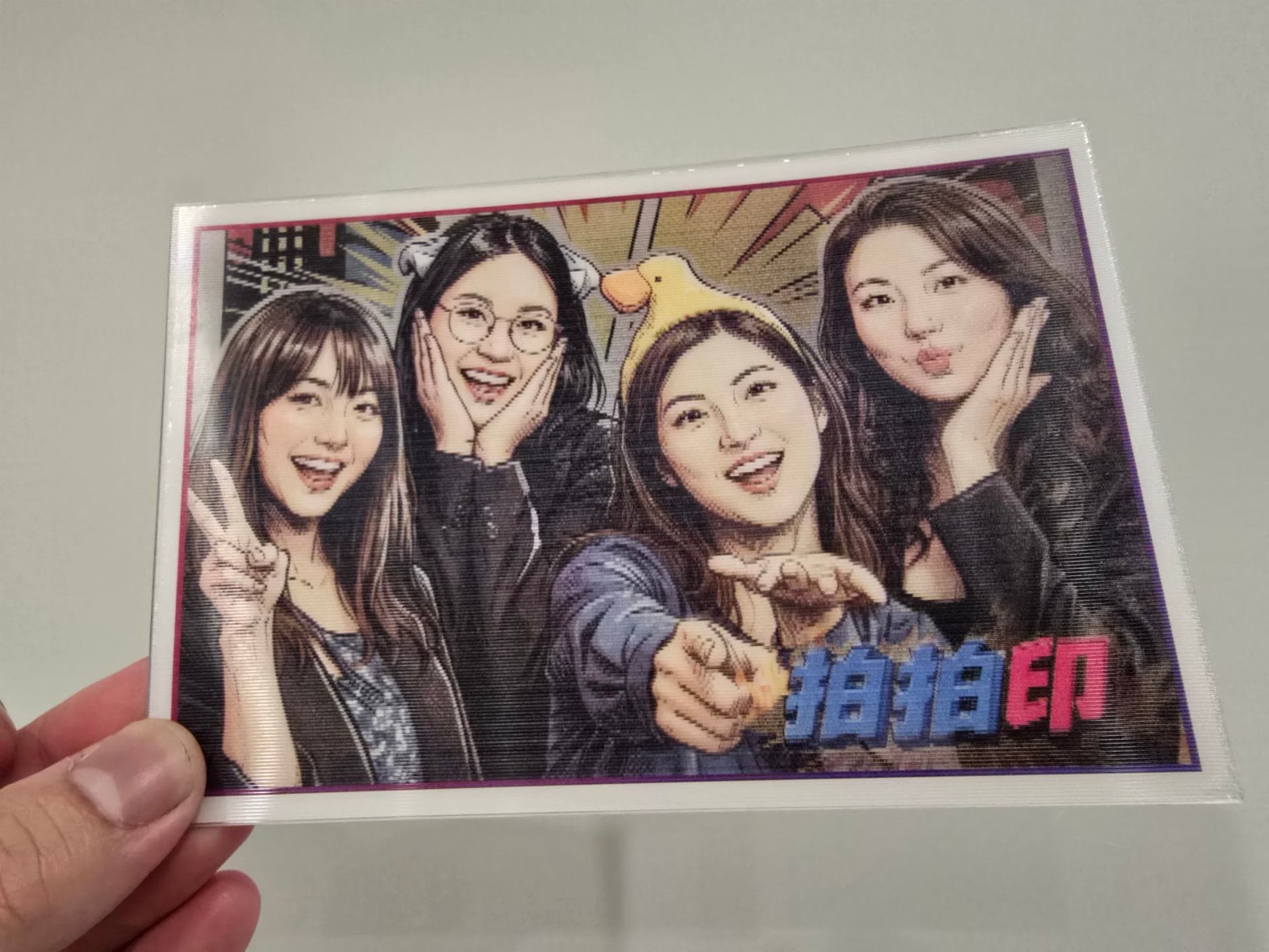 Real shot of the lenticular card tilted to its comic-artwork side