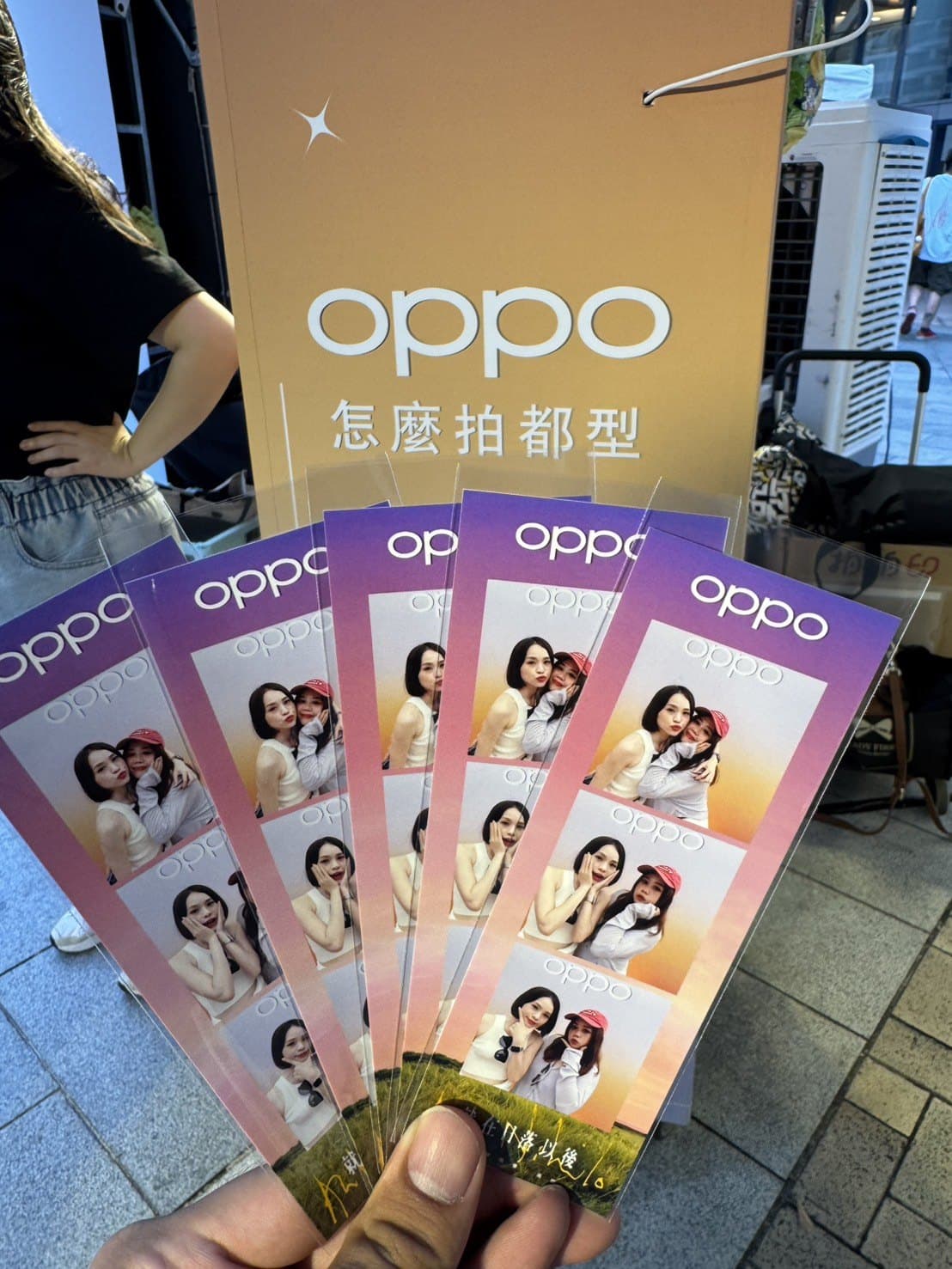 OPPO pop-up store — four branded strips in hand