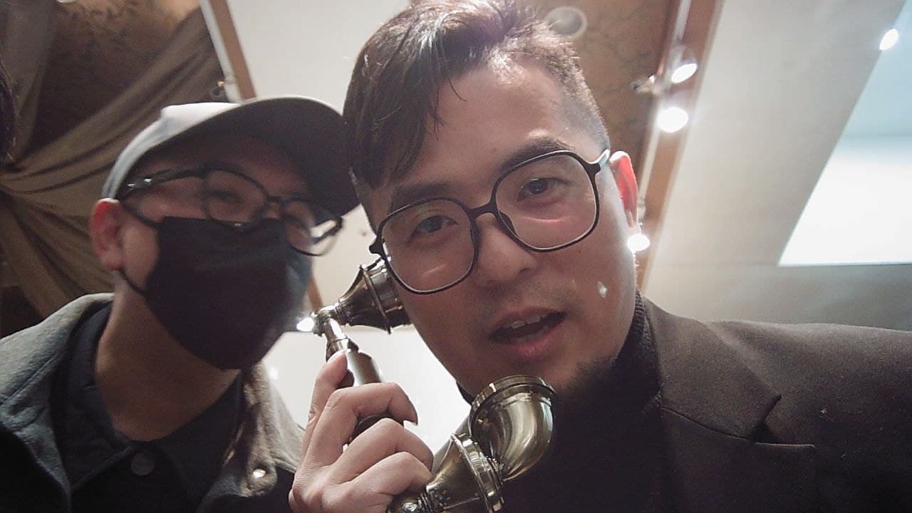Two guests take turns speaking their wishes into the handset at a wedding banquet