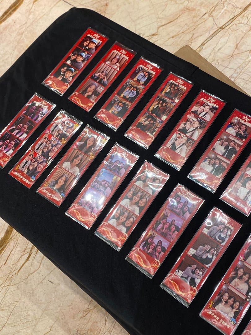 Table full of printed 4-cut strips at a company dinner