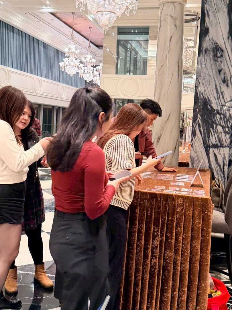 Guests picking up their printed strips at the collection table
