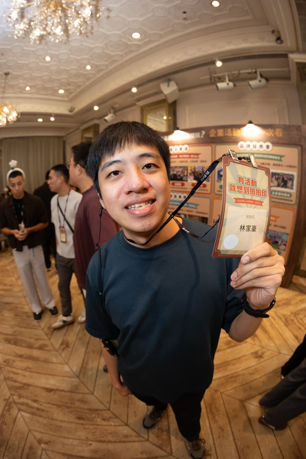 Guest holding a badge at the registration area
