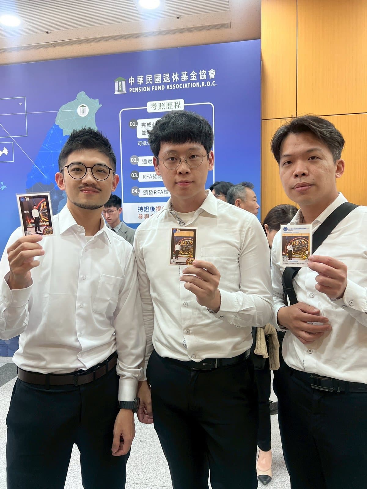 Three guests at a certification ceremony holding their printed AI transformation cards