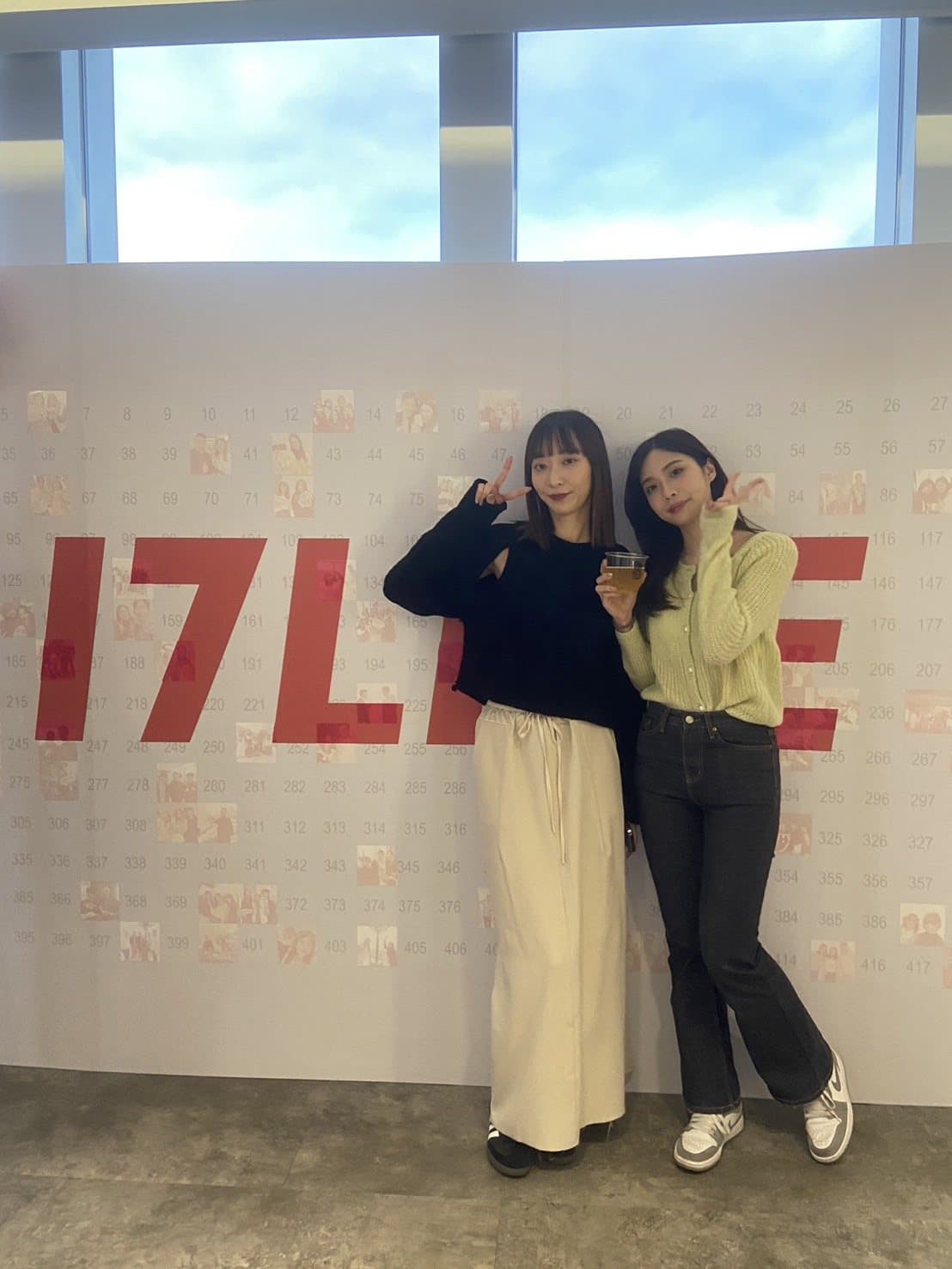 A brand logo mosaic wall with two guests posing in front of the finished piece