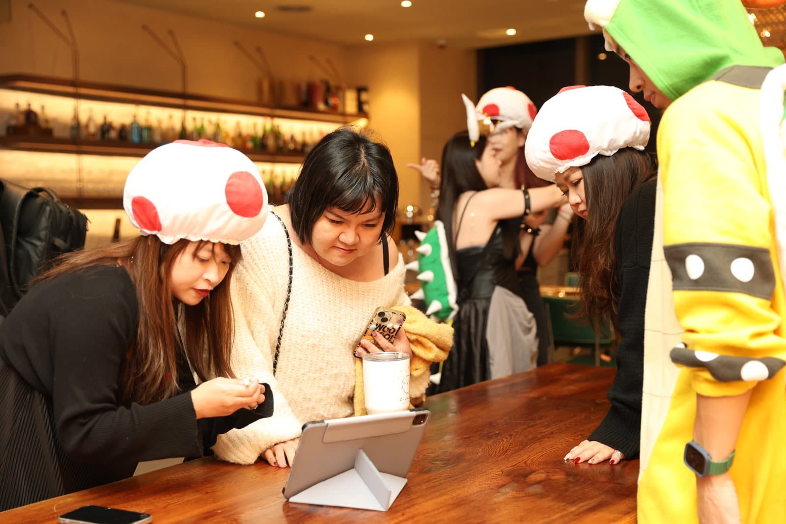Guests gathered around the signing tablet, the crowd buzzing