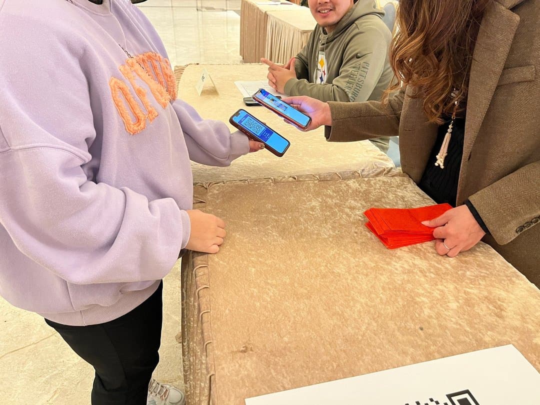 A guest shows their check-in screen; verification completes entry