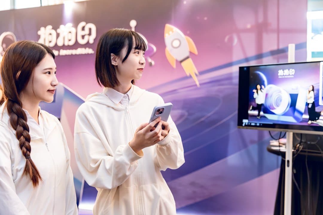 Two guests operating the stamp rally system at the event zone